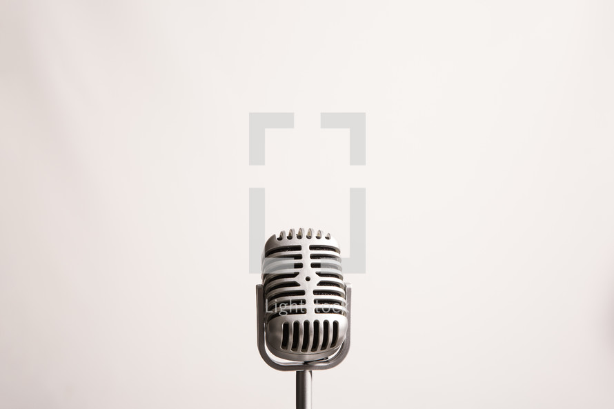 Retro microphone against a white background with copy space.
