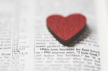 red heart shape on the pages of a Bible 