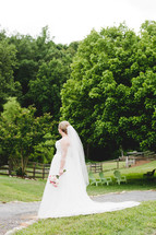 a bride standing on a path outdoors 