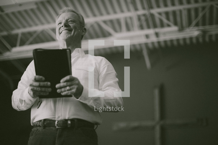 pastor holding a Bible during a sermon