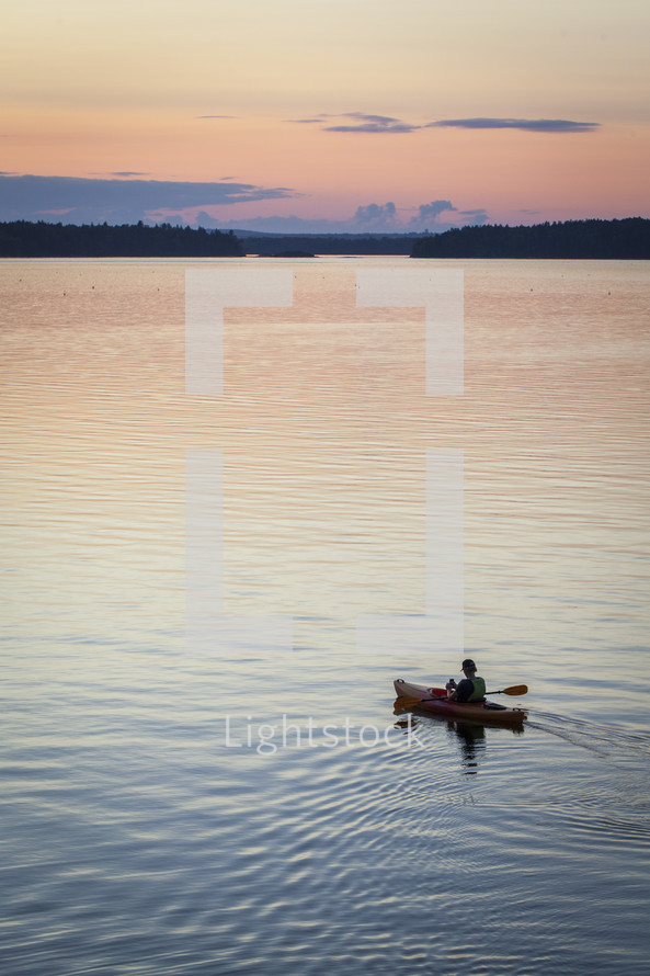 kayaking on a lake at sunset 