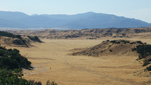 person hiking through a desert mountain landscape 