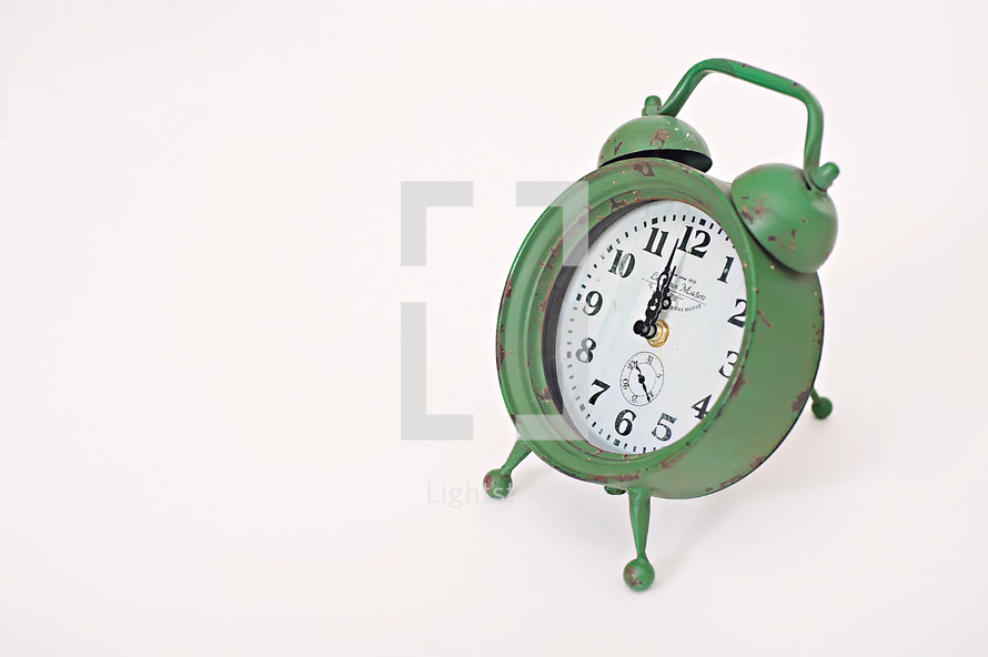 green alarm clock 12:00