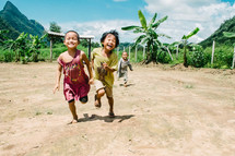 children running in the dirt 