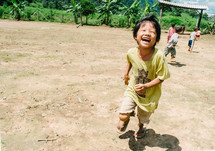 children running in the dirt 