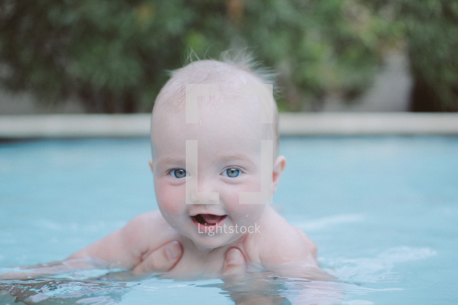 an infant swimming in a pool 