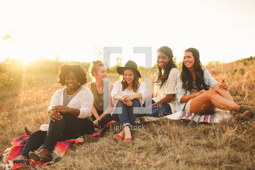 friendship, friends, young woman, african american, woman, college, outdoors, sitting, hill, sunset, blankets, grass