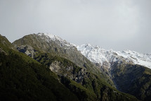 clouds over snowy mountain peaks in New Zealand 