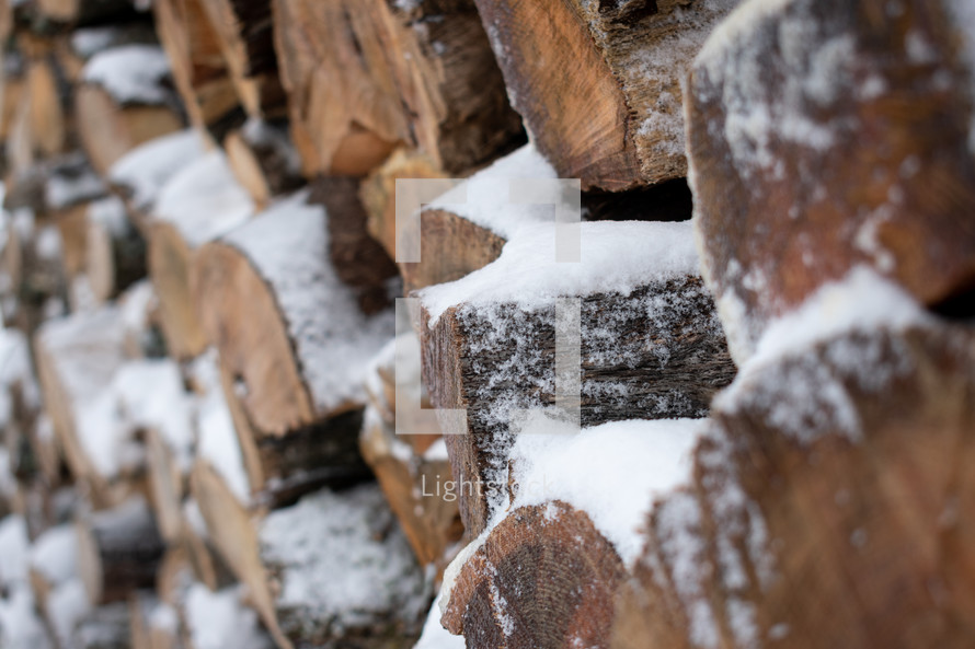snow on wood pile 