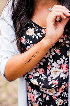 tattoo of Psalm 93:16 on a woman's arm 