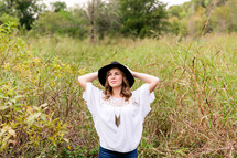 woman in a hat posing outdoors 