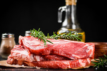 Raw pork steak on a stone board. On a black background. High quality photo