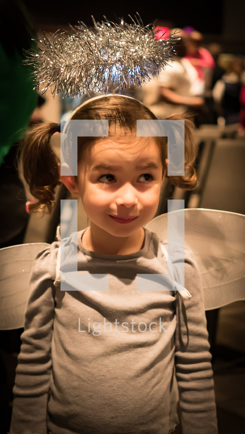 little girl in an angel costume 