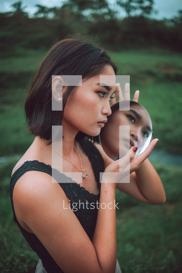 a woman looking at her reflection 
