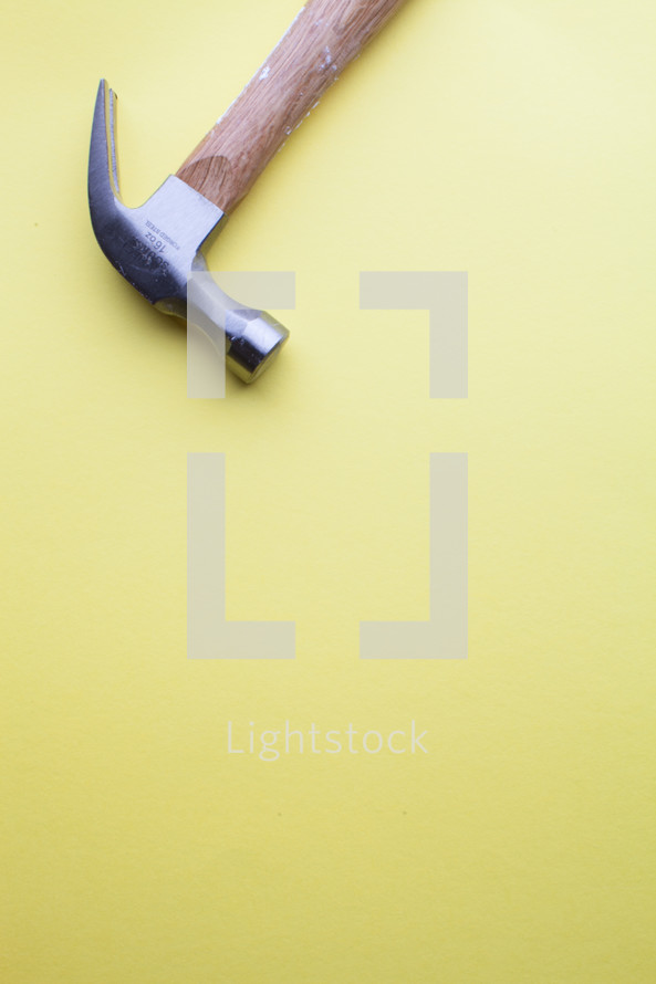 Hammer on a yellow background.