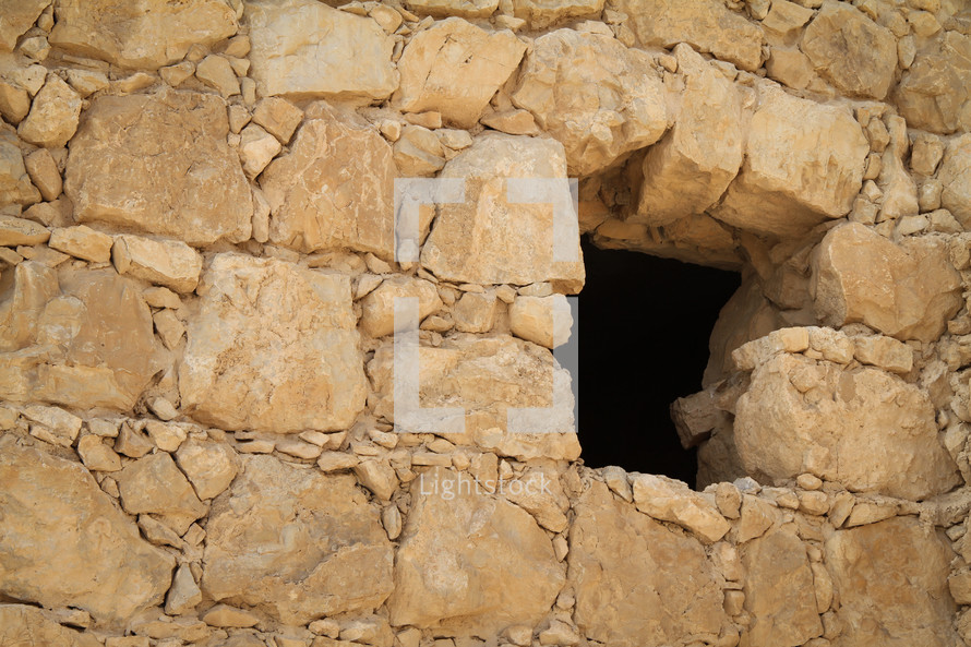 Window in stone wall Masada, Israel