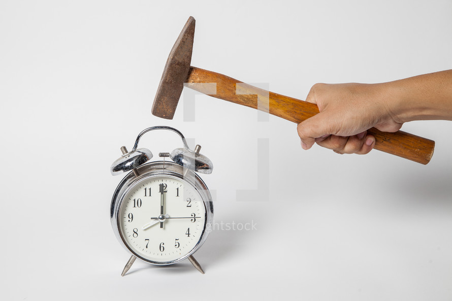 taking a hammer to an alarm clock 