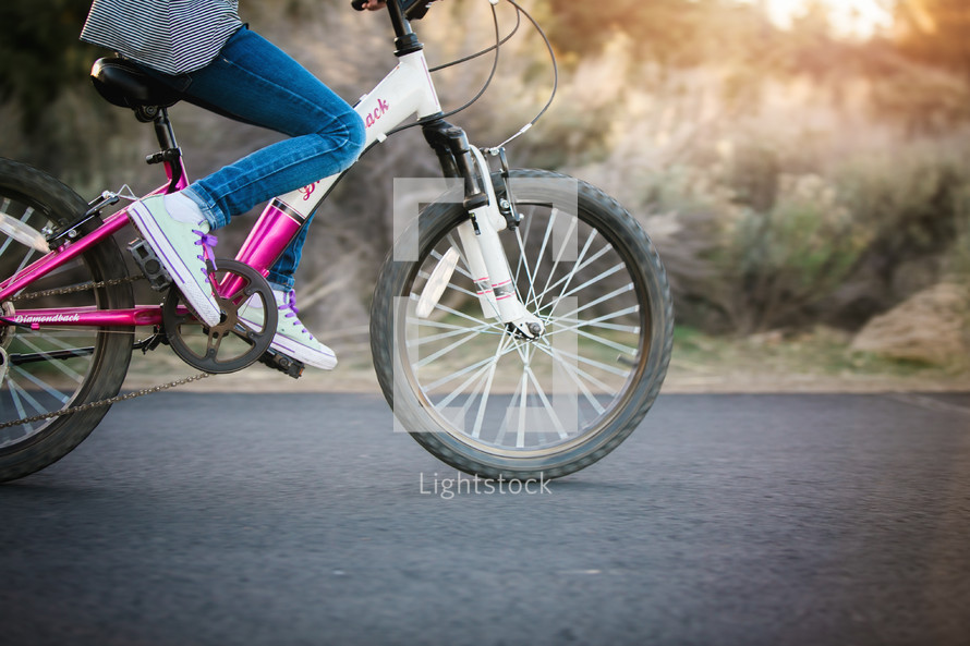 a girl child riding a bike 