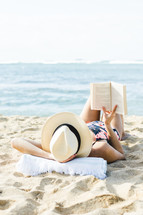 woman reading on the beach in Hawaii 