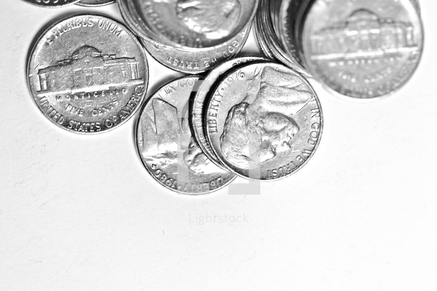 Scattered nickels isolated on white