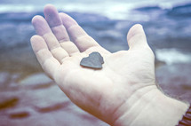 heart shaped rock in palm of the hand 