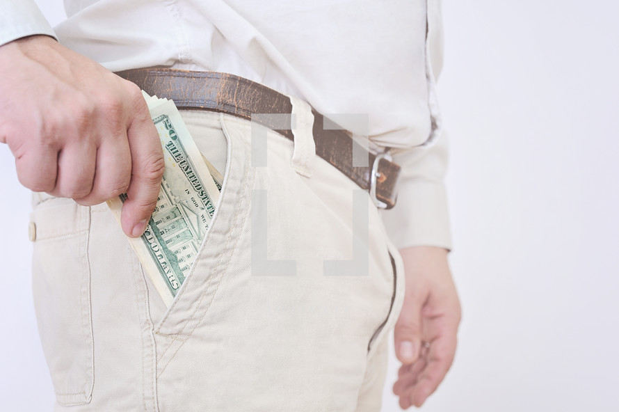man pulling cash out of his pocket 