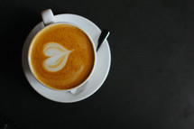 mug of coffee with heart shaped creamer 