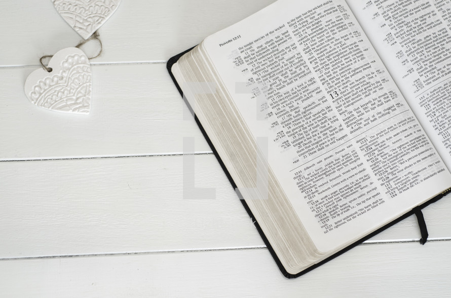 open Bible on a white table 