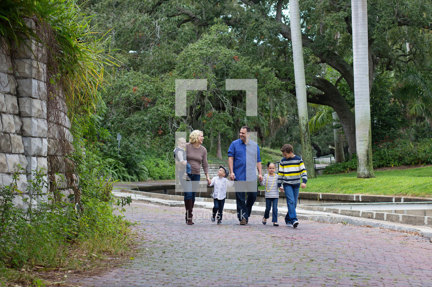 A family walking together along a path.
