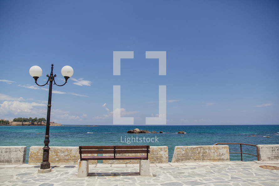 street lamp and bench near the ocean in Greece  