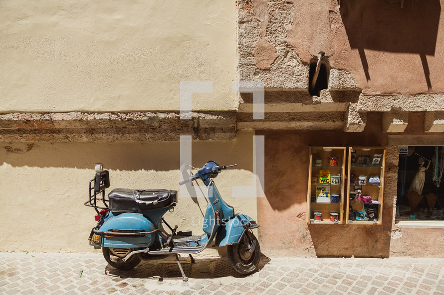 scooter parked on a sidewalk in Greece 