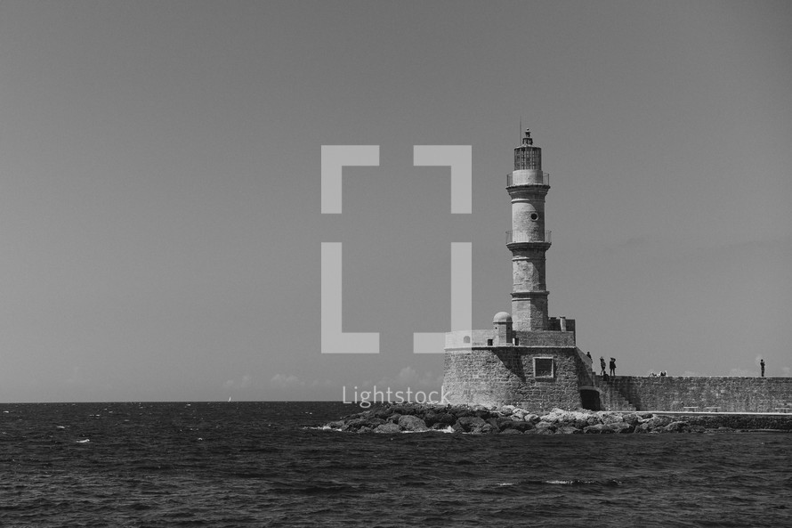 lighthouse at the edge of a sea wall 