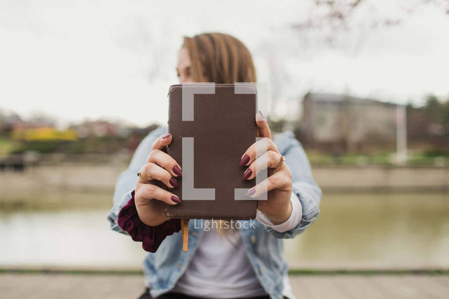 young woman holding a Bible 