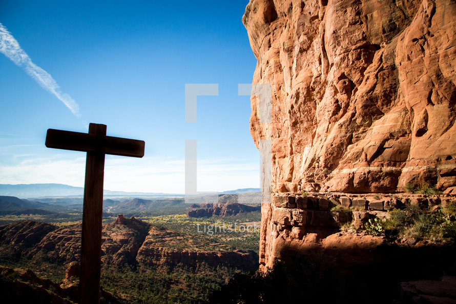 cross silhouette and tall cliff 