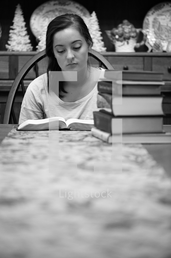 teen girl studying at a table 