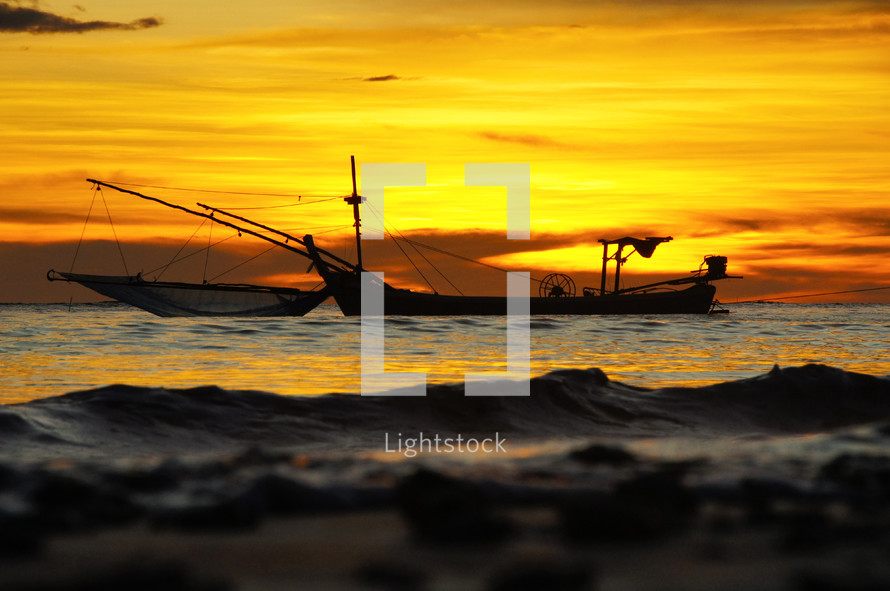 Fishing boats on the sea at sunset