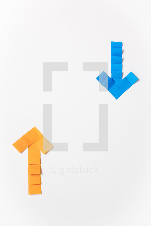 A yellow arrow pointing up and a blue arrow pointing down on a white background.