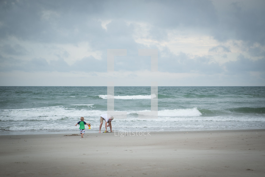 father and son playing on a beach 