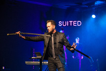 a minister holding a sword during a worship service 