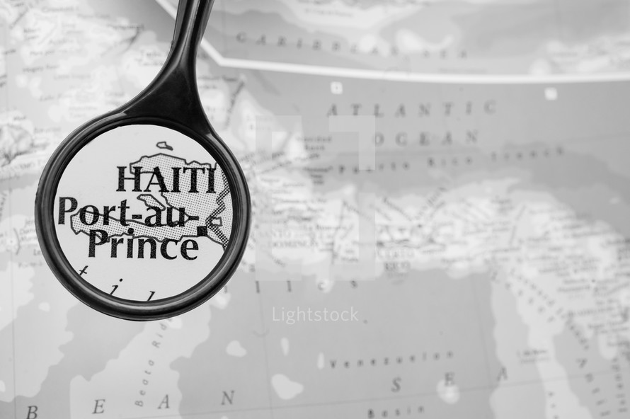 magnifying glass over a map of Haiti