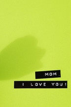 "Mom, I love you," on a green background.