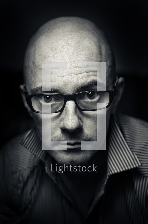 Bald man wearing glasses