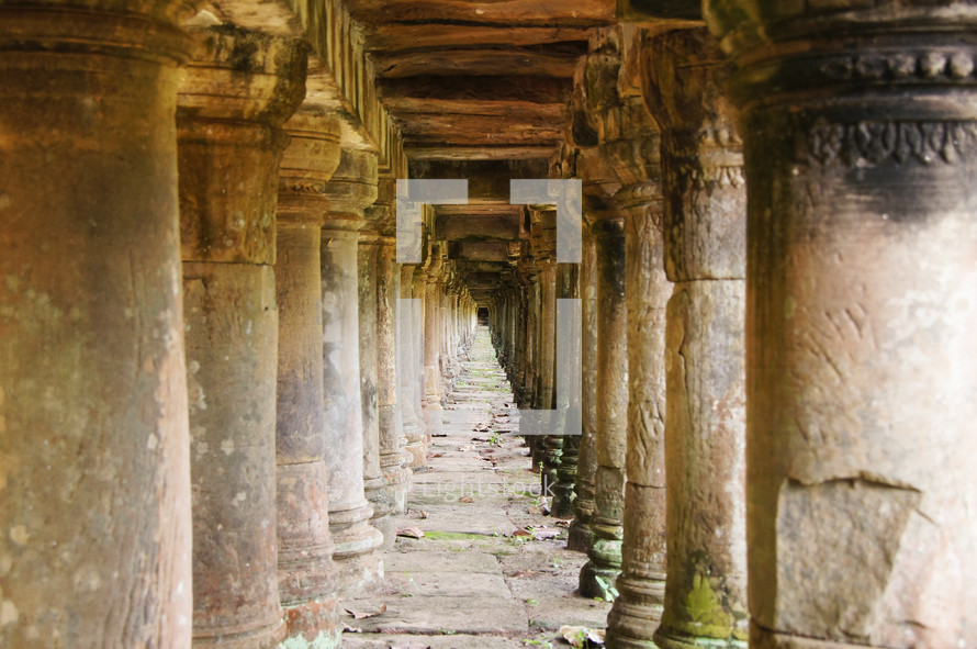 Temple colonnade. Pillars supporting an ancient walkway.

