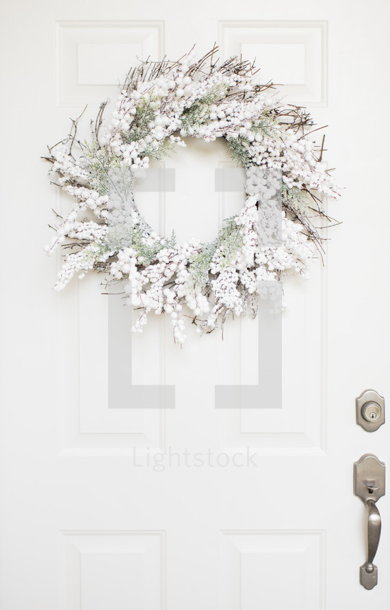 white berry wreath on a door 