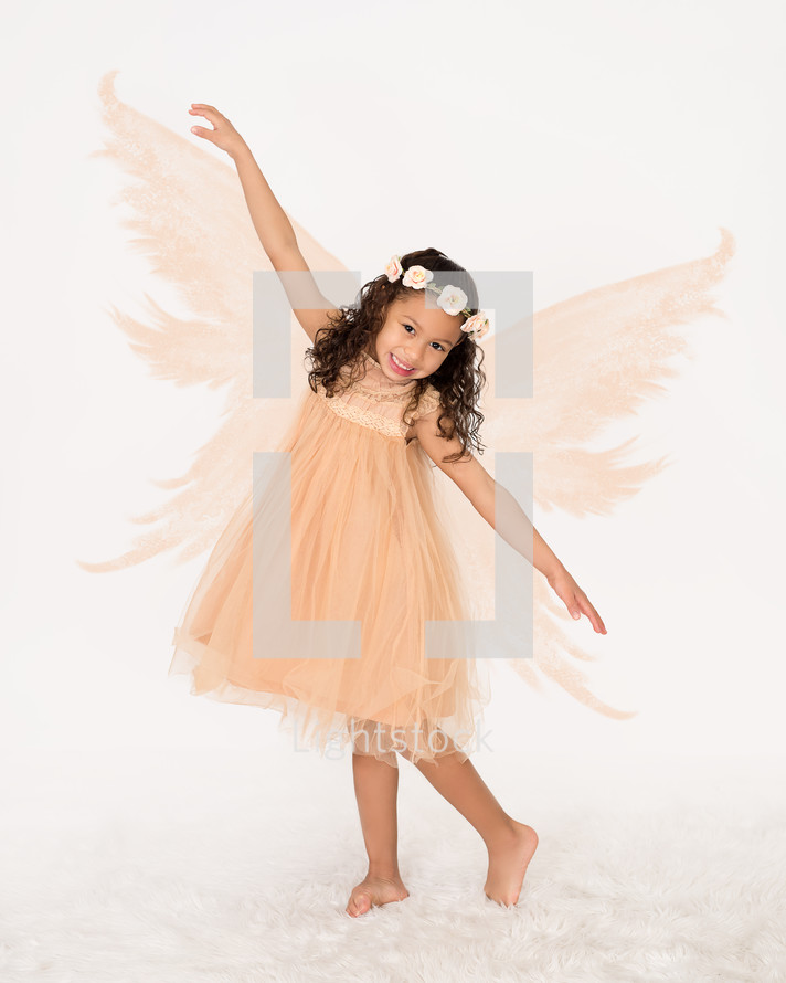 A little girl posing in a fairy costume.