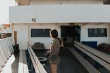 a woman with a camera on a ferry boat 