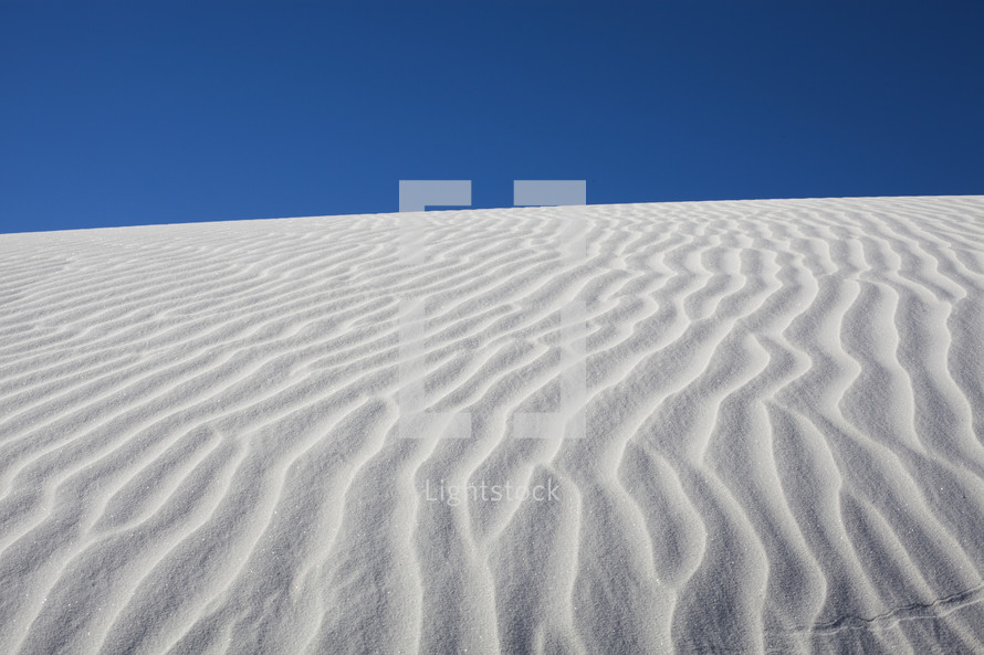 White sand dunes and blue sky