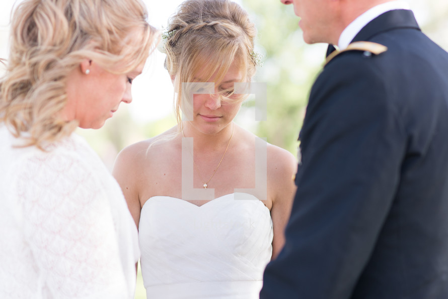 Bride and her parents in prayer.