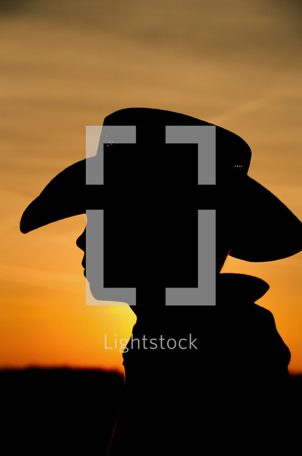 Silhouette of boy in cowboy hat 