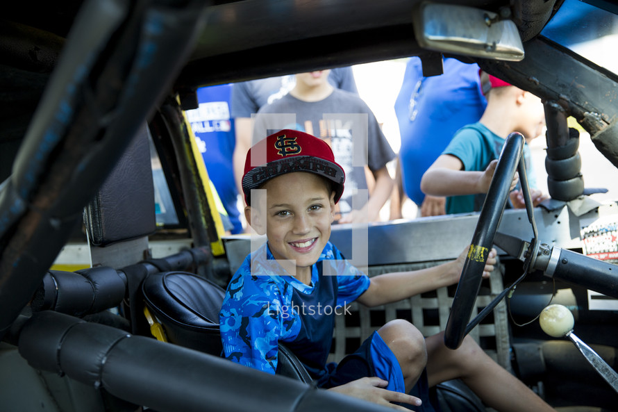child in a Nascar vehicle 
